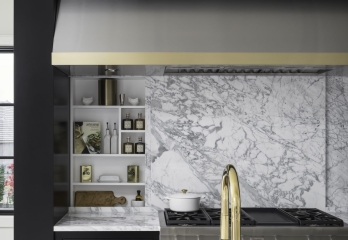 Modern stove hood with black cabinetry