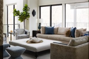 Custom home living room overlooking deck and forest out back