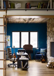 Custom home office with fireplace and ladder built-in bookshelves