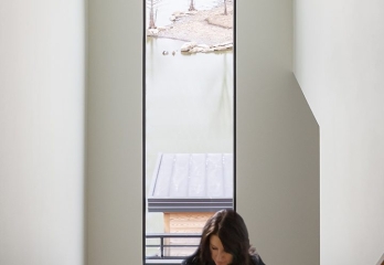 Custom home staircase and tall slim window