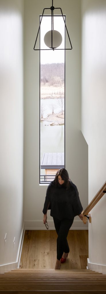 Custom home staircase and tall slim window