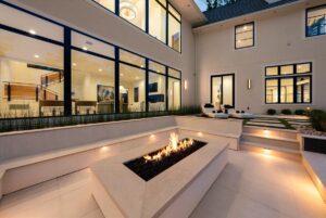 View of outside pool deck and fireplace at custom built Belton MO home