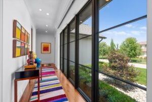 Hallway with floor to ceiling windows in luxury custom home in Overland Park KS