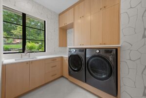 View of laundry room in luxury custom built Belton MO home