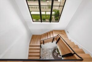 Stairs down to the lower level in luxury custom built Belton MO home