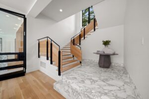 Stairs down to the lower level in luxury custom built Belton MO home