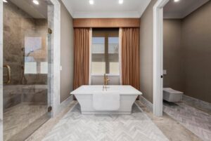 Multi head shower, standalone tub and toilet at luxury ranch in Overland Park Kansas