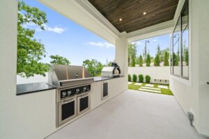 View of the outdoor kitchen and grill of custom built Belton MO home