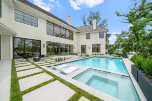 View of the backyard and pool of custom built Belton MO home