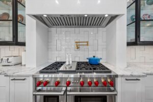 Double oven gas stove and hood in custom luxury ranch in Johnson County KS