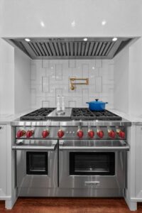 Double oven gas stove and hood in custom luxury ranch in Johnson County KS